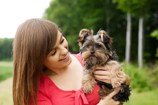 Girl holding cute puppy